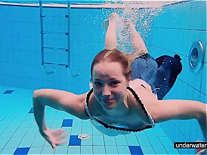 teen chick Avenna is swimming in the pool
